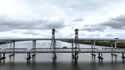 A stunning Aerial View of Pacific Highway Harwood Bridge crosses the Clarence River under a cloudy sky in the Northern Rivers region of New South Wales, Australia 