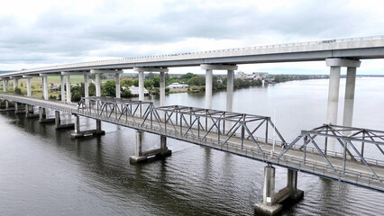 A stunning Aerial View of Pacific Highway Harwood Bridge crosses the Clarence River under a cloudy sky in the Northern Rivers region of New South Wales, Australia 