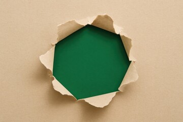 Green paper with a hole and space for text