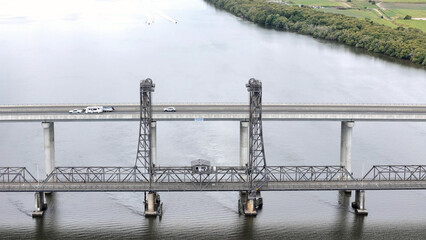 A stunning Aerial View of Pacific Highway Harwood Bridge crosses the Clarence River under a cloudy sky in the Northern Rivers region of New South Wales, Australia 