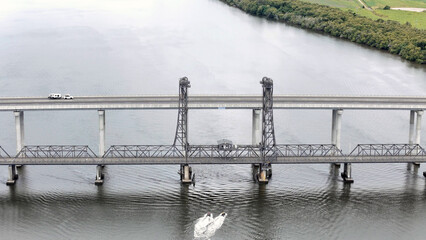 A stunning Aerial View of Pacific Highway Harwood Bridge crosses the Clarence River under a cloudy sky in the Northern Rivers region of New South Wales, Australia 