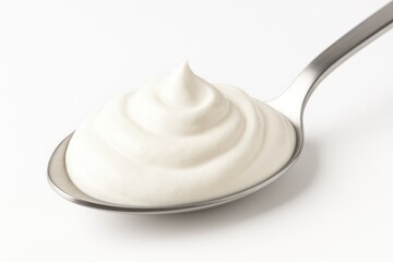Spoonful of creamy sour dairy on a white background