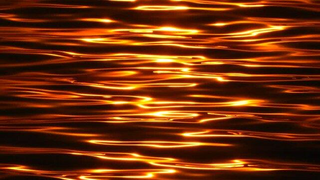 Water sun reflection, golden light rippling on dark water surface at sunset