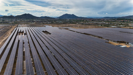 Aerial View of a Large Solar Power Plant in a Scenic Landscape