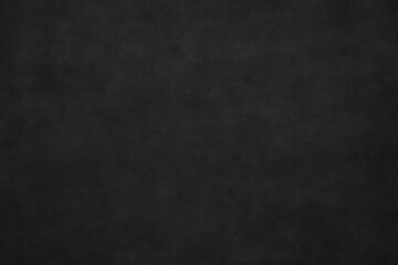 Abstract dark grey textured background with smooth concrete surface featuring black paint accents