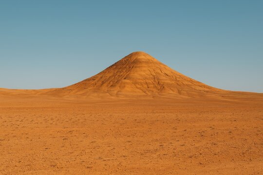 A tiny elevation amidst a barren, arid desert terrain