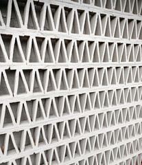 A Wall partition of a building exterior built with concrete cement and steel in slanted pattern,...