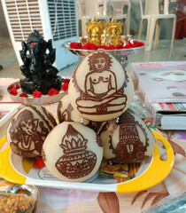 Aesthetically carved religious Gods on dry coconut during Mahavir Jayanti festival in India.