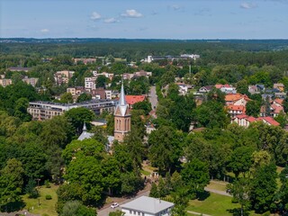 Aerial view of a town with a church and greenery.