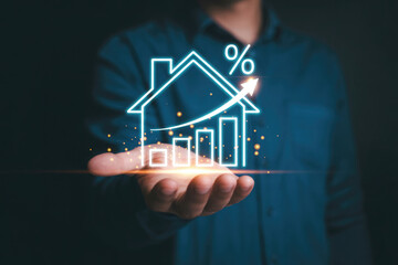 A glowing house with a rising graph sits in a persons hand