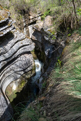 Mountain river in the forest. A beautiful view of Rosomacki Lonci in Slavinja, Serbia. Canyon of Rosomac river, called Rosomacki lonci ( Rosomac pots) or Slavinja throat, with curved and colored roc	