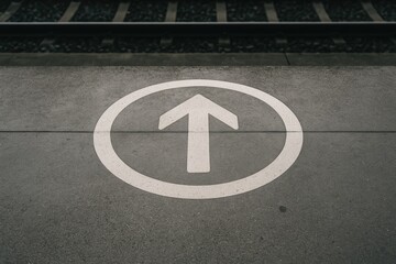 Marking on concrete pavement at a transit hub walkway