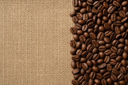 Coffee beans resting on a textured juta fabric