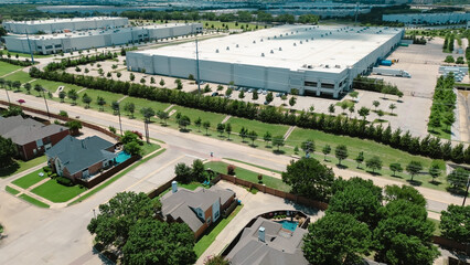 Suburban homes near large warehouses in Coppell, Dallas Fort Worth metroplex, growing hub for...