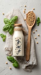 Soy milk with herbs and beans on a textured surface.