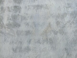 Light Gray Weathered Wall with Subtle Abstract Stains. Close-up of a pale gray weathered surface with fine abstract textures, natural stains, and brush-like patterns. Ideal for backgrounds or design