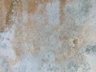 Rust-Stained Weathered Wall Texture with Earth Tones. Detailed texture of a weathered surface with...