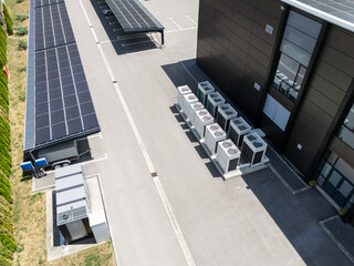 Aerial view of parking space with solar canopies and energy storages