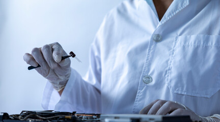 Tech Fixing Electronics in Lab