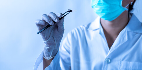 Researcher Examines Sample With Precision Tool