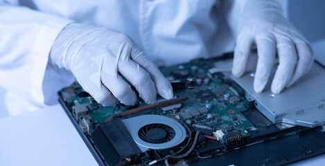 Repairing a Laptop in a Tech Workshop