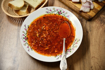 Ukrainian borscht red soup with garlic buns on the table.