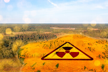 Radiation warning symbol over scenic forest and field landscape, illustrating environmental...