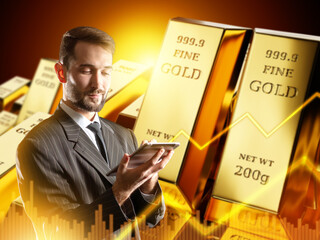 Businessman in suit using tablet with gold bars and financial chart in background, representing...