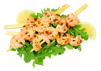 Grilled king prawn skewers with wild rocket salad leaves and lemon slices isolated on a white...