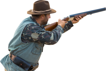 Silhouette of a hunter with a gun in the reeds against the sun, an ambush for ducks with dogs