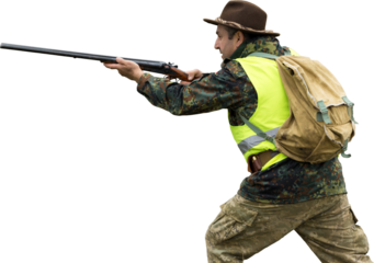 Hunting period, autumn season open. A hunter with a gun in his hands in hunting clothes in the autumn forest in search of a trophy. A man stands with weapons and hunting dogs tracking down the game.