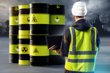Man near barrels with radioactive substance. Guy works in dangerous production. Inspector controls...