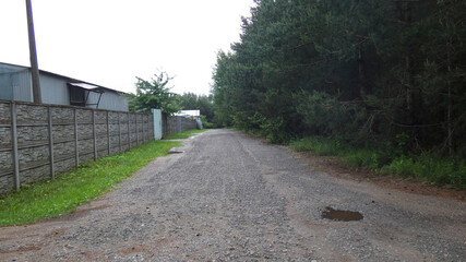 Wet road near an abandoned house