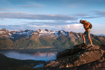 Man tourist hiking solo in mountains of Norway travel vacations climbing adventure outdoor healthy...