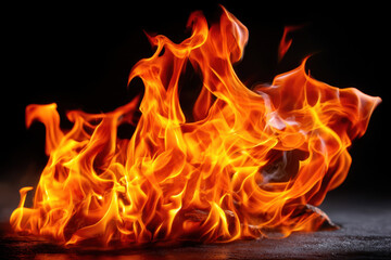 Flames dance vibrantly in a dark setting creating an intense visual spectacle