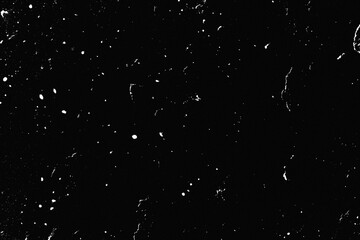 Natural dust particles float in air on black background. Noise black background overlay. Speckled Rough grainy noise dusted structure. Grungy surface. Retro gritty effect overlay.