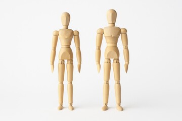 Wooden Couple Figurines Displayed as Human Dummies on White Background