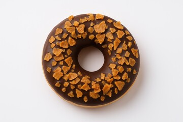 Aerial view of a donut topped with chocolate and flaky crepe pieces on a white surface