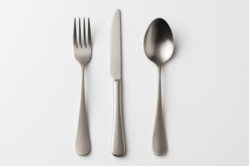 Complete cutlery collection featuring a fork, knife, and spoon on a plain white backdrop