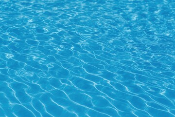 Detailed shot of vibrant blue water with dynamic movement and selective focus in a swimming pool surface