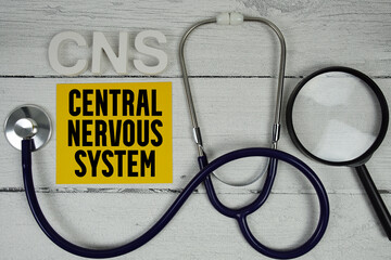CNS Central Nervous System text with Stethoscope on wooden background