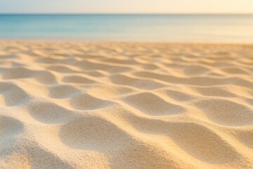 Fototapeta premium Close-up of fine sand at a tropical shoreline showing smooth color transitions from white to yellow, highlighting sunlight's warm glow and natural seaside charm