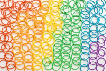 Vibrant arc-shaped rubber bands forming a colorful backdrop