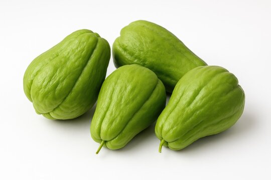 Individual chayote vegetable displayed on a plain white backdrop