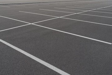 Empty blacktop lot marked with white stripes