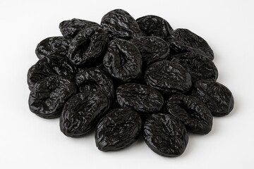 A collection of delicious dried plums on a plain white surface, showcasing a healthy snack option
