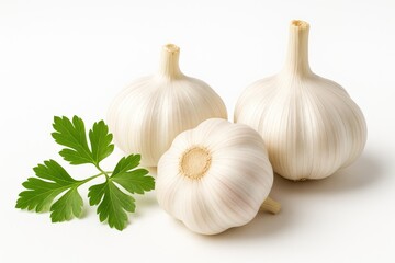 Close-up of garlic bulbs and fresh green parsley on a white background