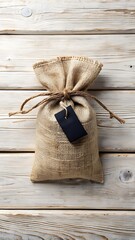 A burlap sack tied with rope sits on a wooden surface