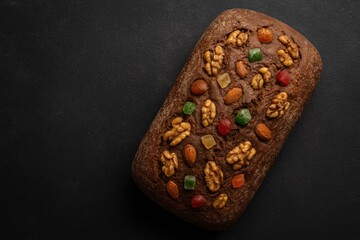 Homemade freshly baked rye loaf with nuts and candied fruits, top perspective