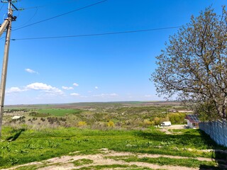 A beautiful blue sky with a few clouds and a tall pole in the background. The sky is clear and the...